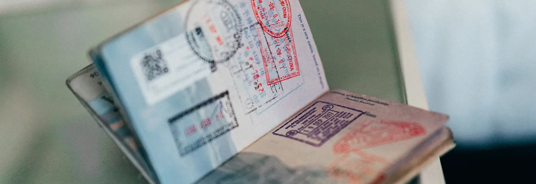 A passport open at a page of entry and exit stamps